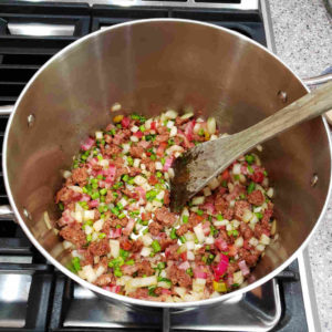 Add the diced onion and diced green stems to the mix.