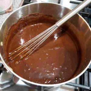 Slowly stir in some stock. It becomes a chocolate brown batter.