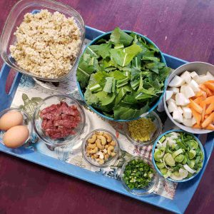 Mise: Ingredients sliced and chopped - Turnips, greens, carrots, green garlic, ginger, scallions, Chinese sausage, cashews, eggs and rice.