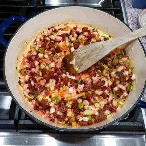 Add the diced onions, beet stems and garlic, and continue to sauté until the onions are soft and translucent.