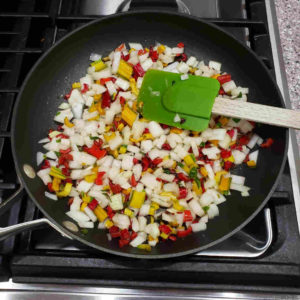 Sauté diced onions and diced chard stems in olive oil, using an oven safe non-stick pan.