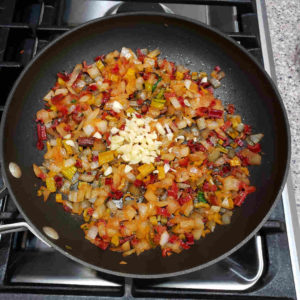 Once the onions are translucent and softened, add minced garlic and sauté another minute or two.