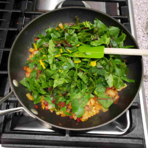 Add chopped chard in batches. Stir from bottom to top, to expose chard to heat.