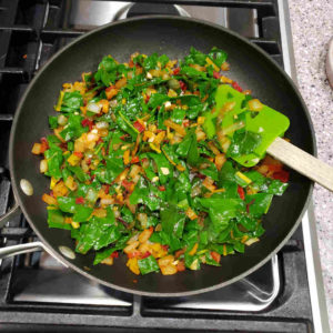 Once a batch is fully wilted, you can add another batch of chopped chard greens.