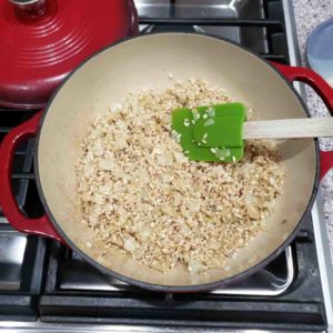 Stir in the rice, coating each grain in the aromatic mixture.