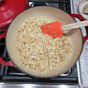 Stir in the rice, coating the rice in the aromatics.