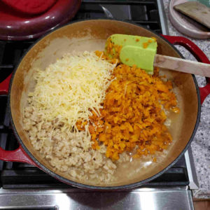 Stir in the finely chopped roasted carrots and the cheese.