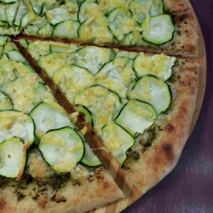 Pizza! Thin sliced zucchini on top of carrot top pesto.