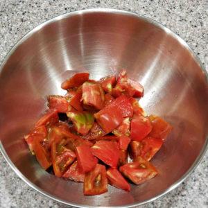 Chop the other half of the tomatoes, put in a mixing bowl, and stir in a little salt and sugar.