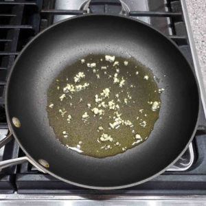 Gently sauté a couple minced cloves of garlic in two tablespoons of olive oil.