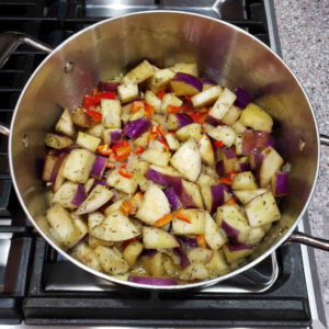 Add the eggplant to the pot, along with 2 teaspoons of dried herbs, a cup of stock and 8 oz of chopped sweet red pepper.