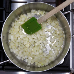 Dice and sauté a medium onion (6-8 oz) in either butter or olive oil, along with a good pinch of salt.
