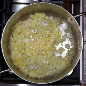 As the onions get soft, add in a few minced cloves of garlic.