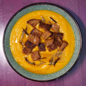 Cream of kabocha squash soup with house croutons and rosemary infused olive oil.