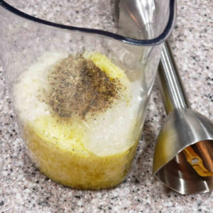 Put the grated cheese, some olive oil, and black pepper with the gel in a container suitible for an immersion blender.