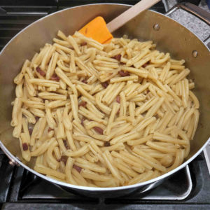 Turn the heat back to medium-low. Add the still hot, freshly drained pasta to the skillet and stir with the pork, garlic and pepper.