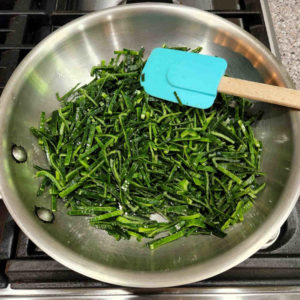 Sauté with a tablespoon or so of olive oil - enough to make them glisten. Add a good pinch of salt as well.
