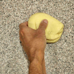 Give the dough ball a quarter turn.