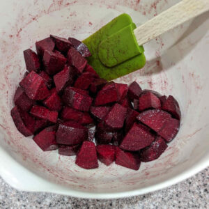 The first thing is to clean up the beet roots, dice them, season them with cumin, salt and olive oil, spread them out on a baking sheet and get them into an oven preheated to 450°F.