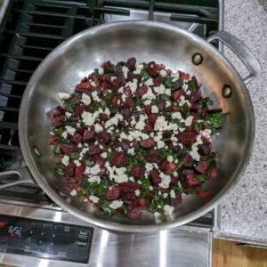 Spread the beets over the top of the sautéed mixture. Also spread the crumbled feta.